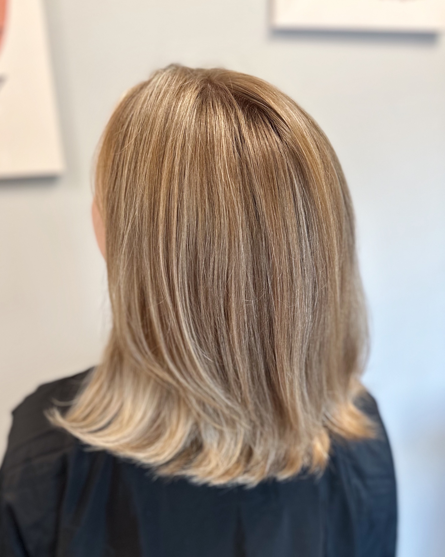 Natural blonde highlights on a layered lob with soft blowout finish in Glen Allen, VA salon
